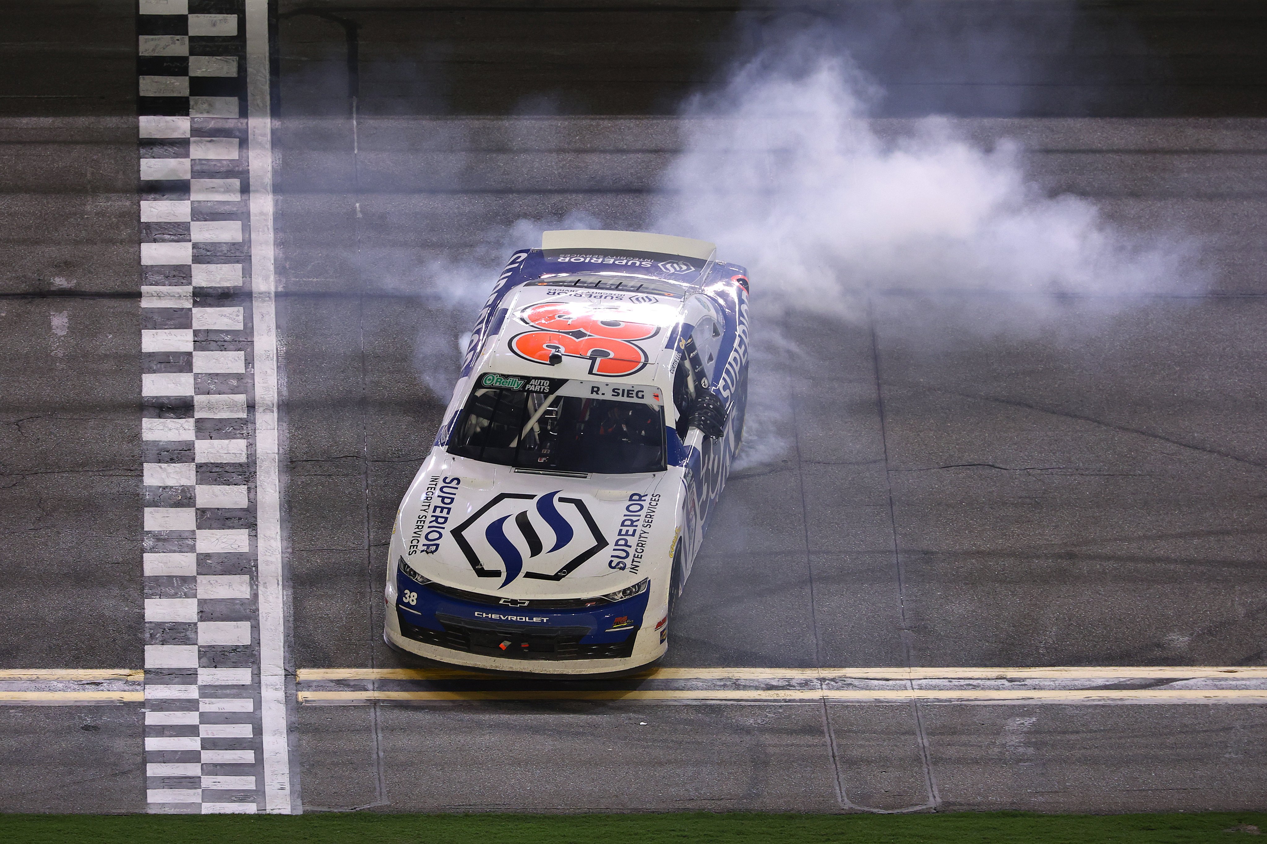 The Superior Integrity Services No. 38 doing a burnout after the win at Daytona.